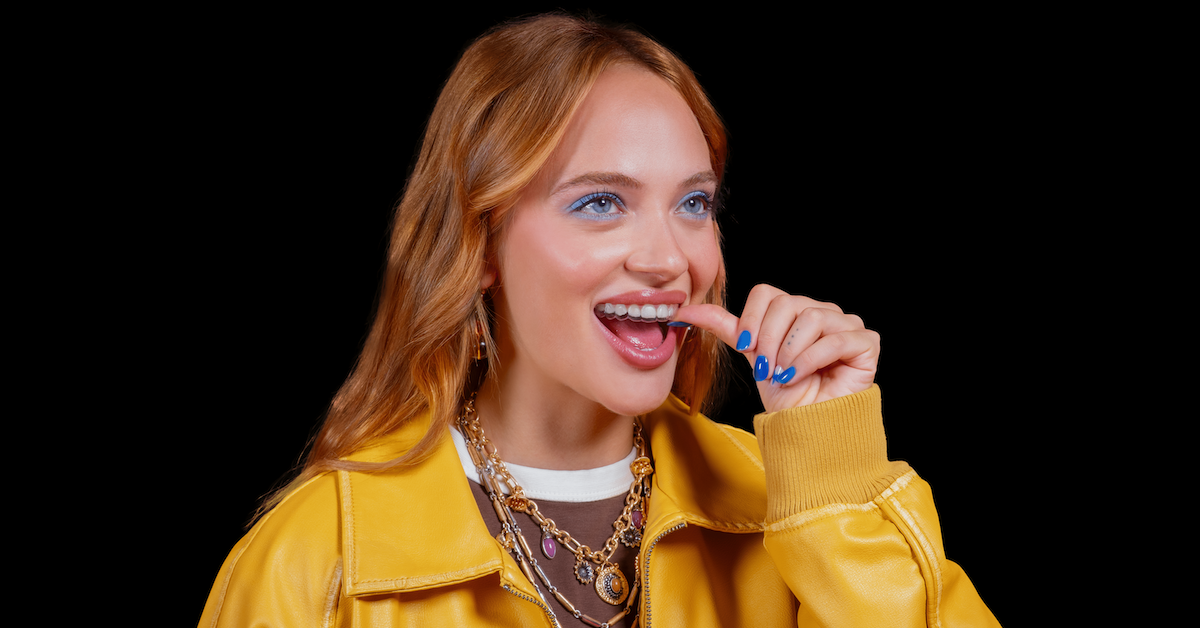 Girl positioning her aligners to push them into place