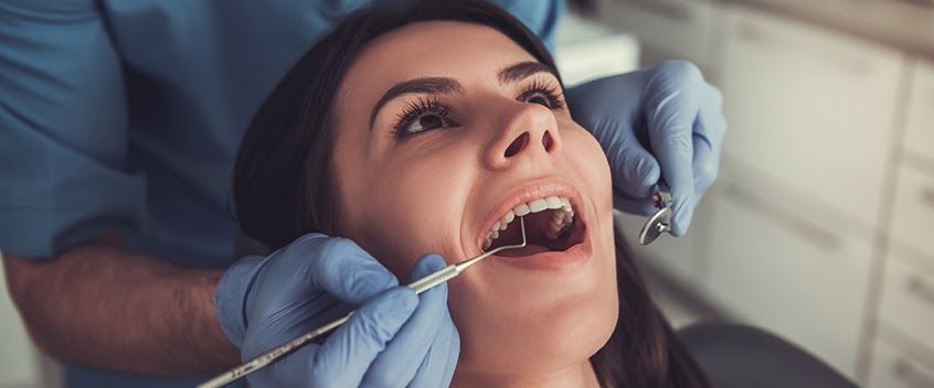 Orthodontist evaluating the a patient’s oral health