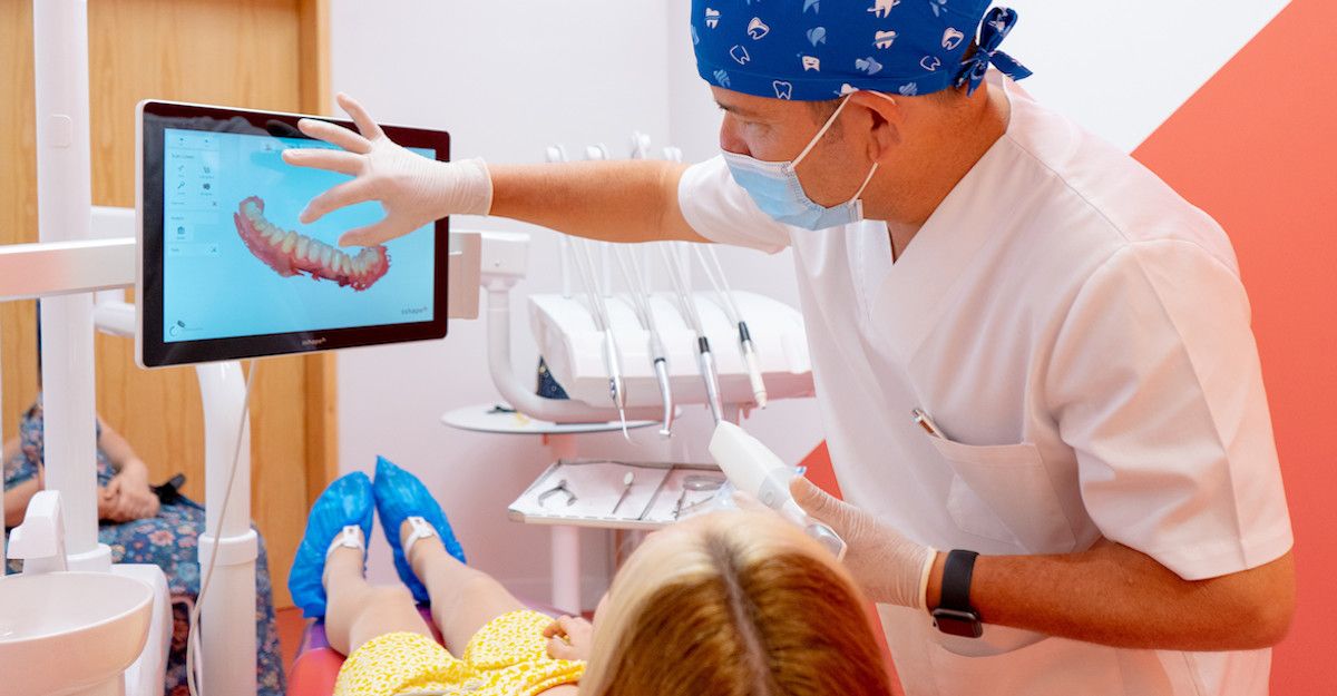 A doctor and a patient looking at 3D scan of teeth.