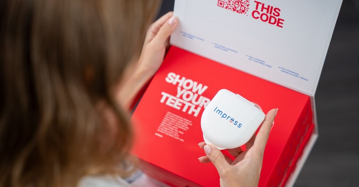 Woman holding her Impress aligner case and the Impress kit