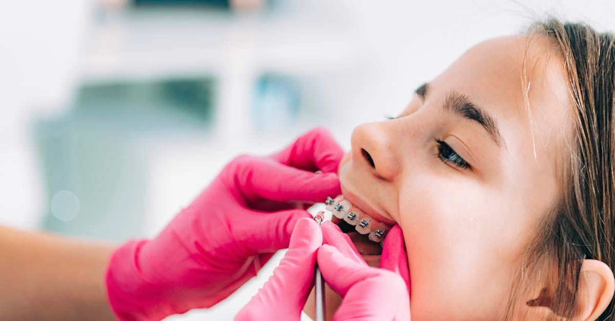 Young patient getting her braces checked