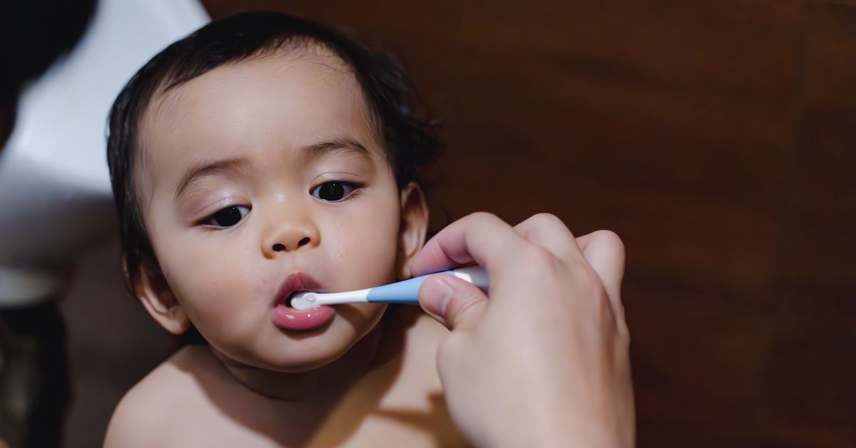 Cute baby brushing their milk teeth