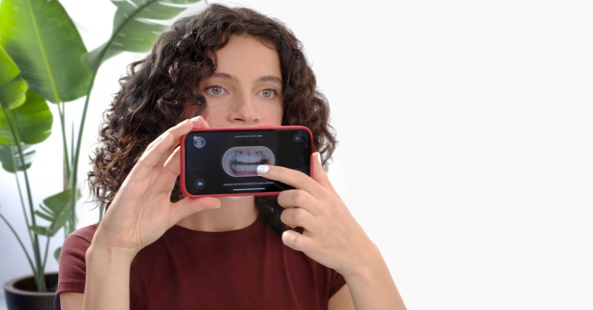 Patient taking progress photos to upload to the Impress App for medical review