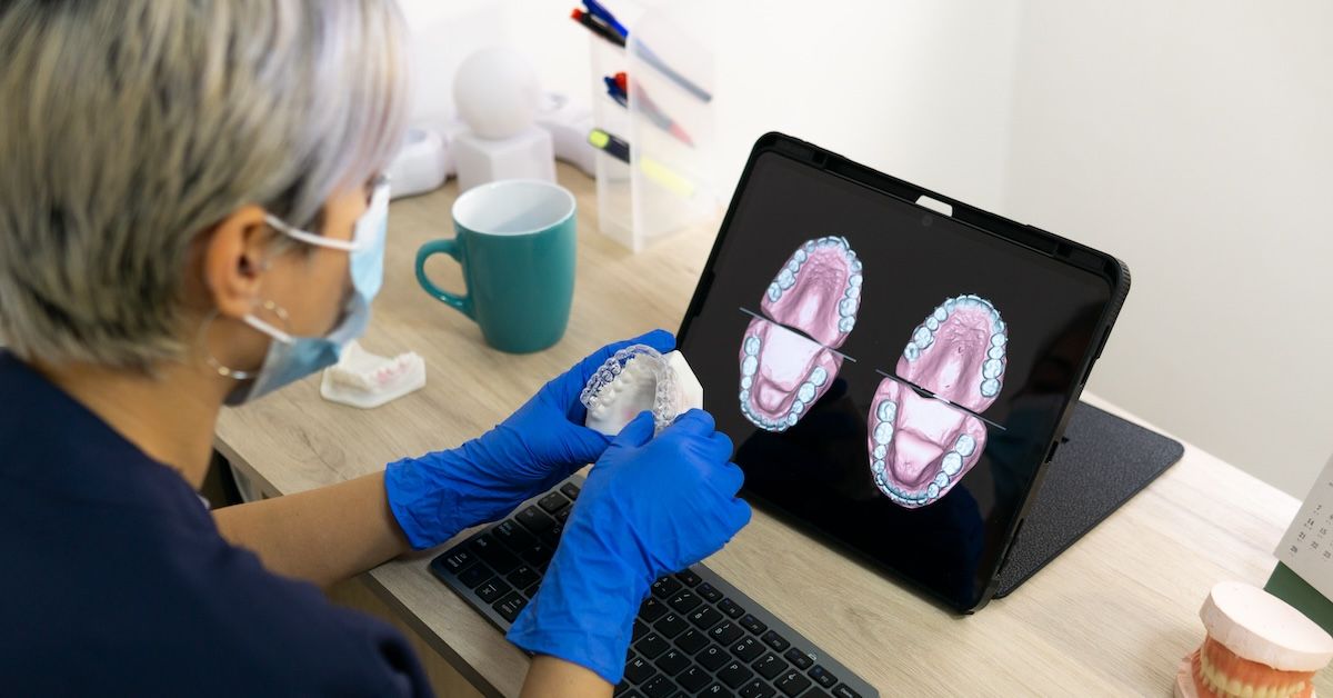 A dentist reviewing dental impressions in digital form