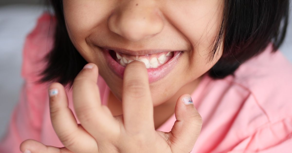 Young girl biting her nails