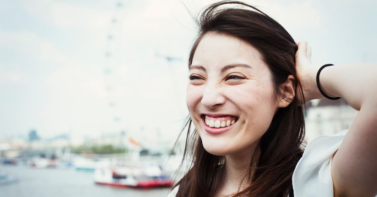 Smiling woman with painless aligner treatment